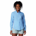 a woman wearing a blue shirt and shorts