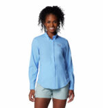 a woman wearing a blue shirt and shorts