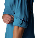 A close up of a man in a blue shirt side view