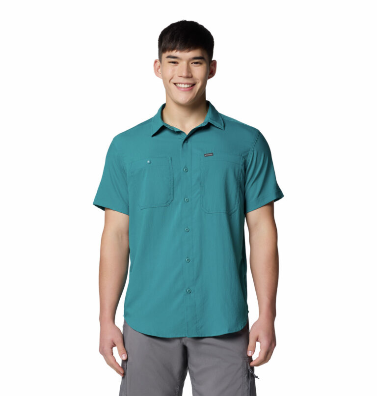 A man wearing a blue short sleeve shirt