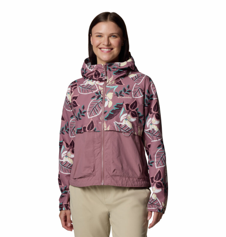 a women wearing a pink multi colour windbreaker jacket