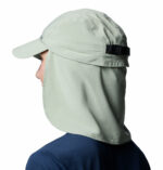 a woman wearing a brown cap with a back flap