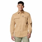 a man wearing a brown long sleeve shirt