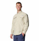 a man wearing a brown long sleeve shirt