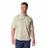 a man wearing a brown long sleeve shirt