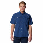 A man wearing a blue short sleeve shirt