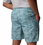 a man wearing blue pattern water shorts