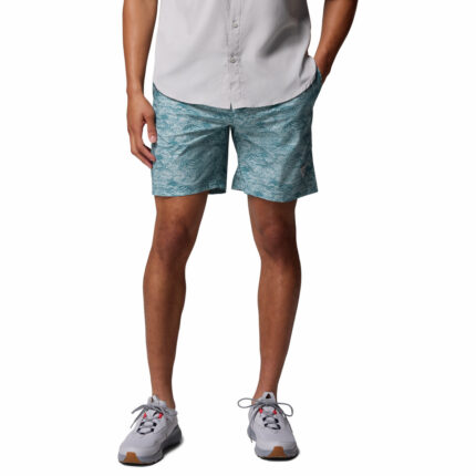 a man wearing blue pattern water shorts