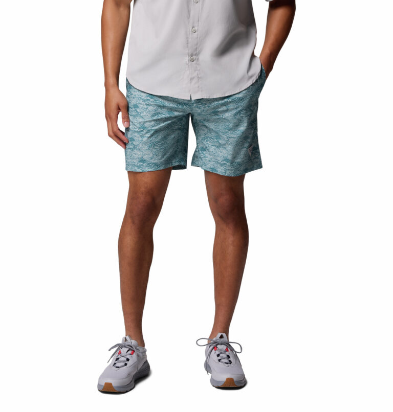 a man wearing blue pattern water shorts