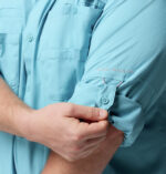 A man wearing a blue long sleeve shirt