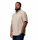 A man wearing a brown short sleeve shirt