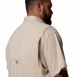 A man wearing a brown short sleeve shirt
