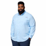 a man wearing a blue Tamiami II Long Sleeve Shirt