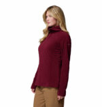 a women wearing a red glacial iv half zip fleece jacket