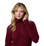 a women wearing a red glacial iv half zip fleece jacket