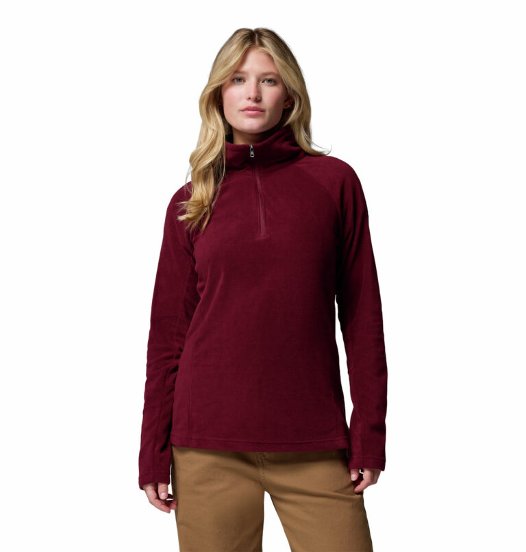 a women wearing a red glacial iv half zip fleece jacket