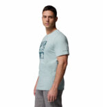 a man wearing a blue csc seasonal logo tee