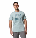 a man wearing a blue csc seasonal logo tee