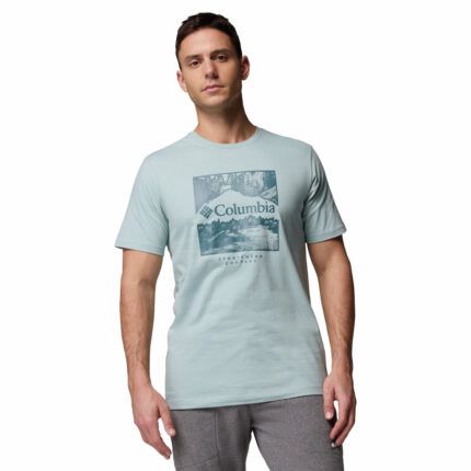 a man wearing a blue csc seasonal logo tee