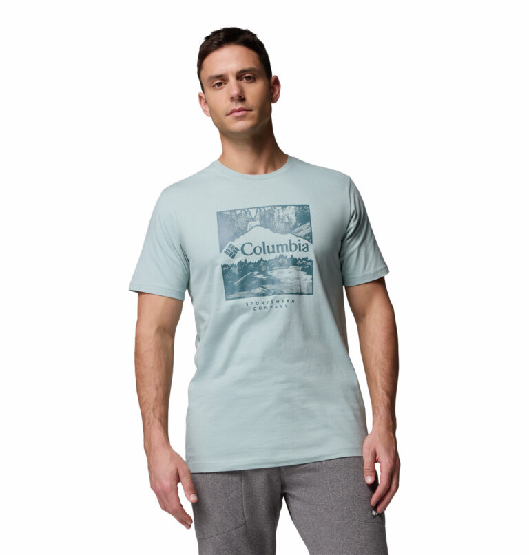 a man wearing a blue csc seasonal logo tee
