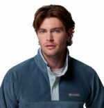 a man wearing a blue half snap fleece pullover