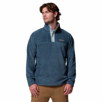 a man wearing a blue half snap fleece pullover