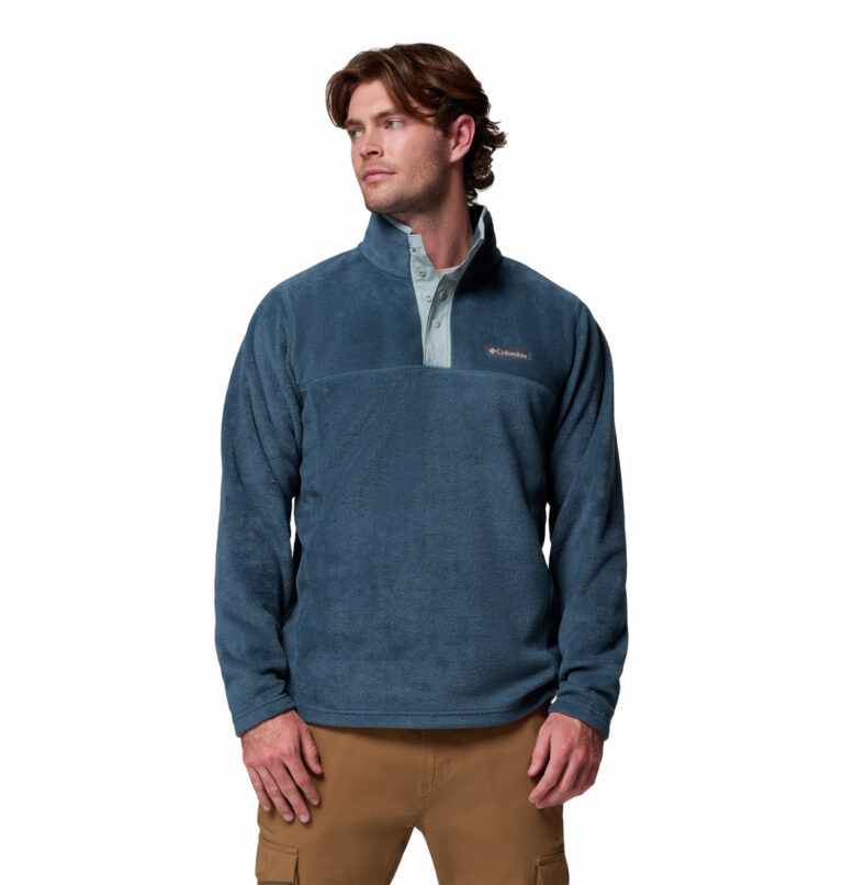 a man wearing a blue half snap fleece pullover