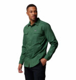 a man wearing a green long sleeve shirt