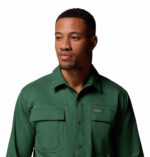 a man wearing a green long sleeve shirt