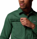a man wearing a green long sleeve shirt