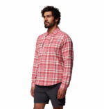a man wearing a pink flannel long sleeve shirt
