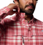 a man wearing a pink flannel long sleeve shirt