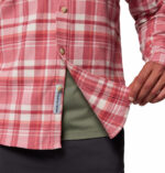 a man wearing a pink flannel long sleeve shirt