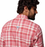 a man wearing a pink flannel long sleeve shirt