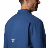 a man wearing a blue long sleeve fishing shirt