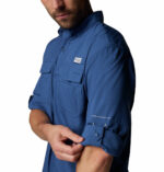 a man wearing a blue long sleeve fishing shirt