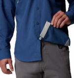 a man wearing a blue long sleeve fishing shirt