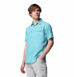 a man wearing a blue short sleeve fishing shirt