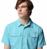 a man wearing a blue short sleeve fishing shirt