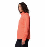 a women wearing a orange essential hike grid half zip fleece
