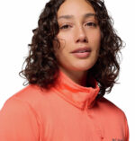 a women wearing a orange essential hike grid half zip fleece