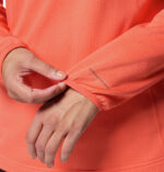 a women wearing a orange essential hike grid half zip fleece