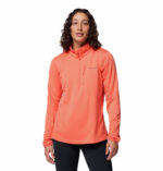 a women wearing a orange essential hike grid half zip fleece
