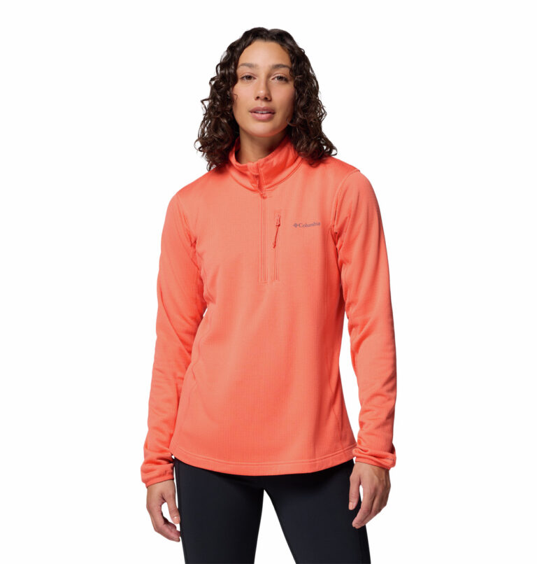 a women wearing a orange essential hike grid half zip fleece