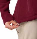 a women wearing a red Fast Trek II Full Zip Fleece Jacket