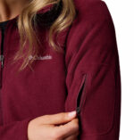 a women wearing a red Fast Trek II Full Zip Fleece Jacket