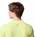 a man wearing a yellow endless trail running tech tee