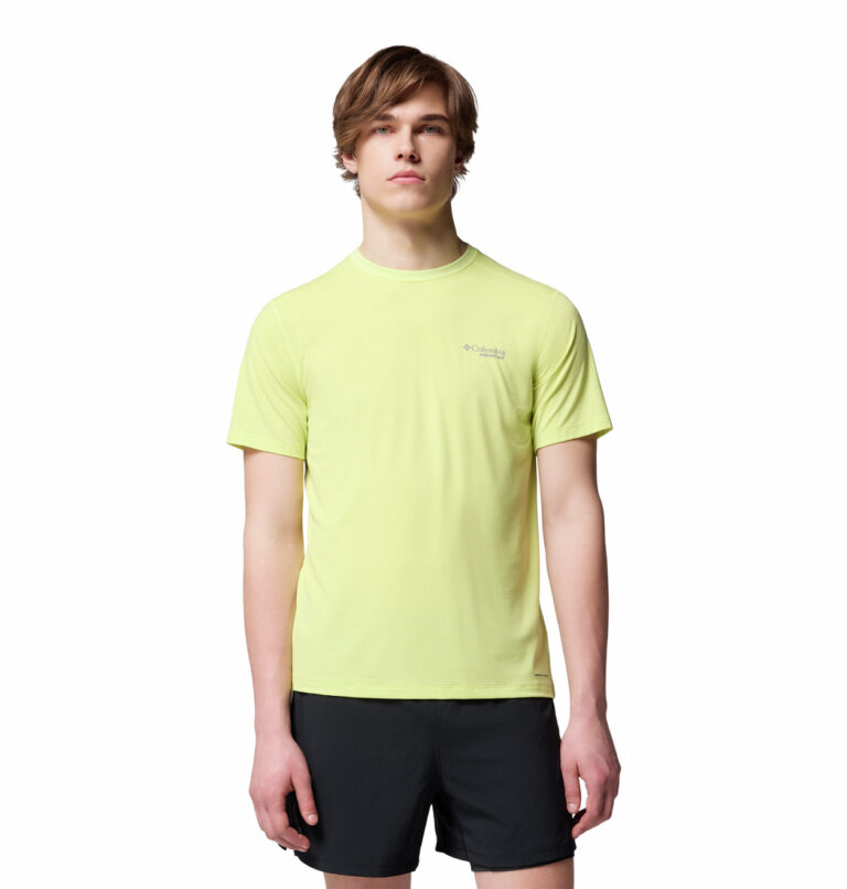 a man wearing a yellow endless trail running tech tee