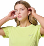 a woman wearing a yellow endless trail running tech tee