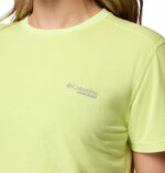 a woman wearing a yellow endless trail running tech tee